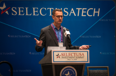 Cameron speaking at the SelectUSA Investment Summit podium